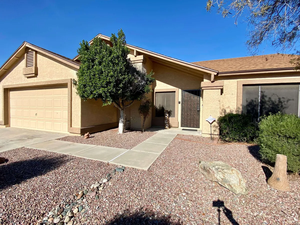 A welcoming exterior shot showcasing the front door, attractive landscaping, and a spacious garage. The pathway invites guests towards the home, hinting at both curb appeal and the ease of coming and going for neighborhood adventures.