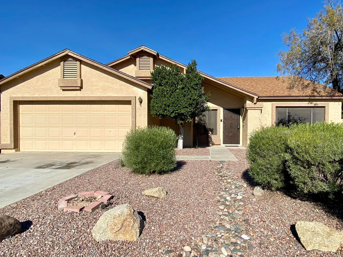This exterior shot showcases the front door, garage, and landscaped yard, highlighting a welcoming and inviting entrance. The space suggests a comfortable home base that's well-kept—perfect as a launching point for local sports and entertainment adventures.